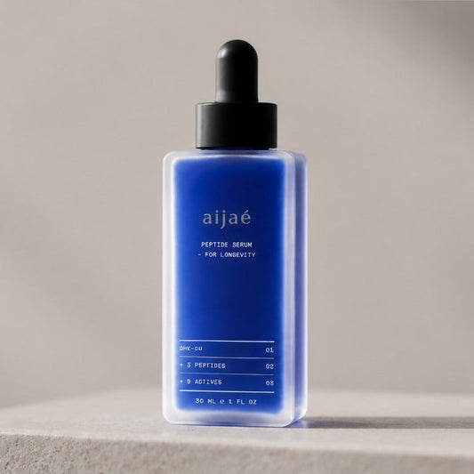 Aijaé peptide serum bottle on a stone plinth